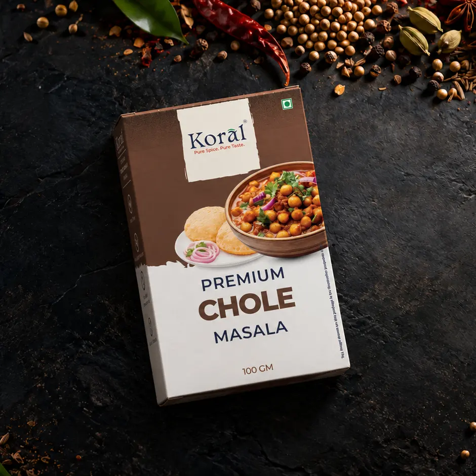 The Chole Masala box lying on dark slate among whole spices