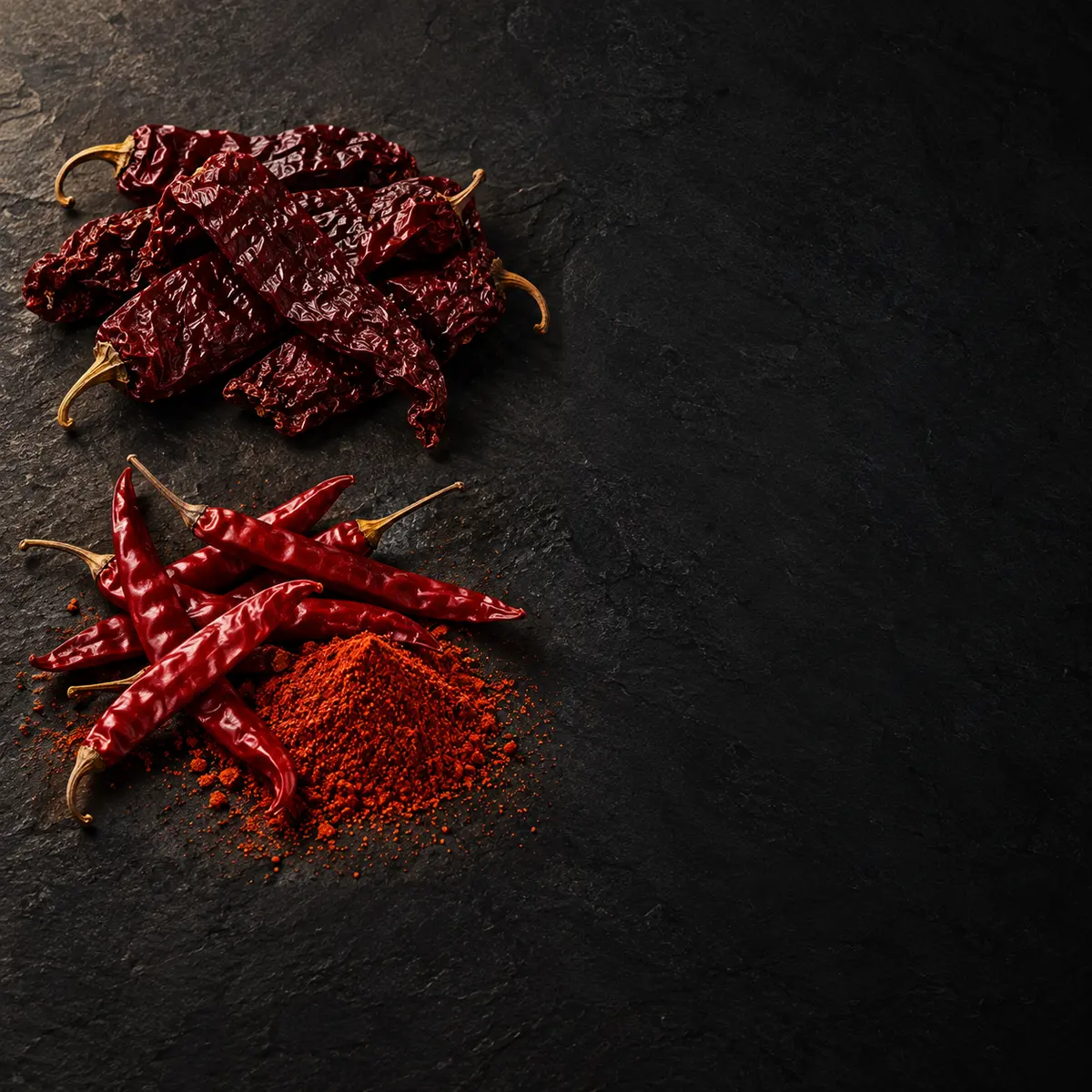 The key ingredients of Red Chilli Powder, laid out on slate: byadgi chilli and guntur chilli