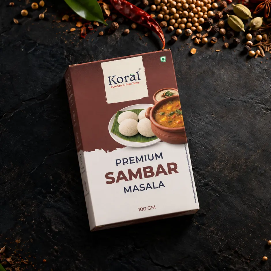 The Sambar Masala box lying on dark slate among whole spices